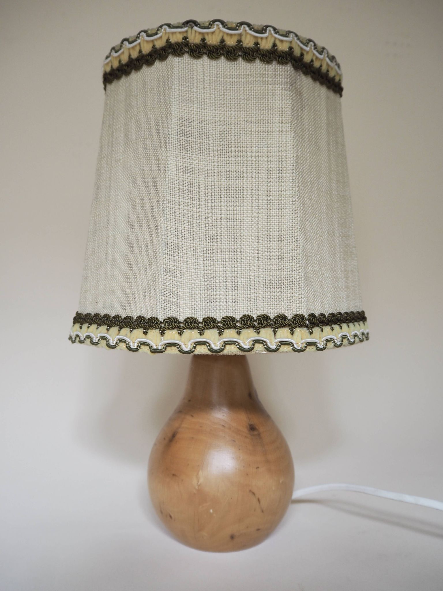 Turned wooden lamp with linen shade