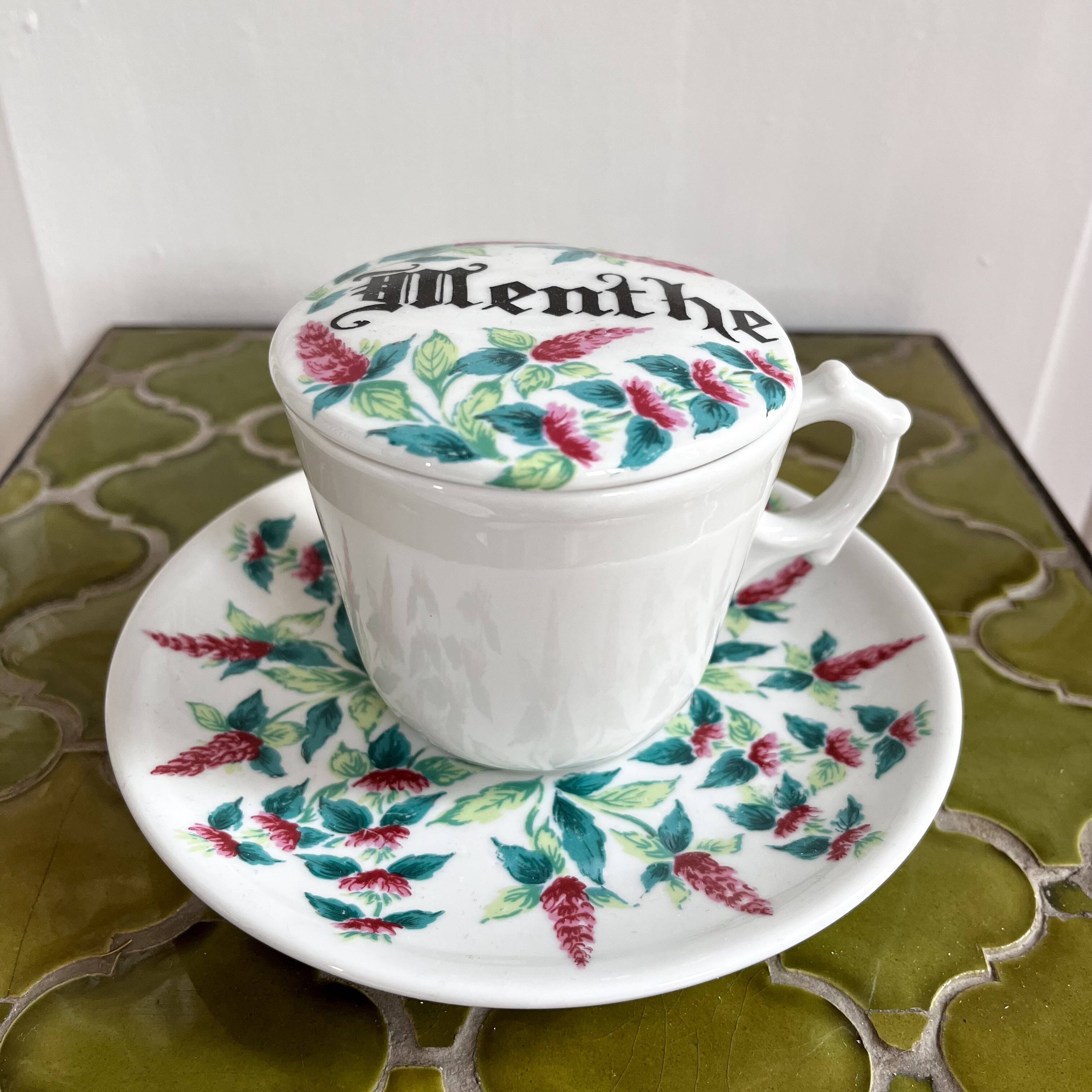 Antique herbal tea cup with mint infusion