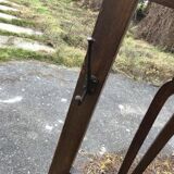 Antique brown wooden coat rack with mirror and umbrella stand, 1900 style.