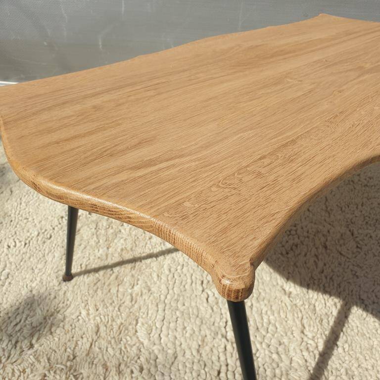 Violin-shaped coffee table with brass legs