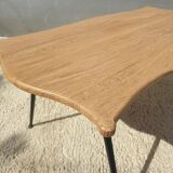 Violin-shaped coffee table with brass legs