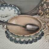 Old iron earthenware sauce boat on frame