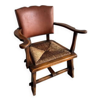 Brutalist dark brown solid wood armchair with natural rattan seat and cognac leather back
