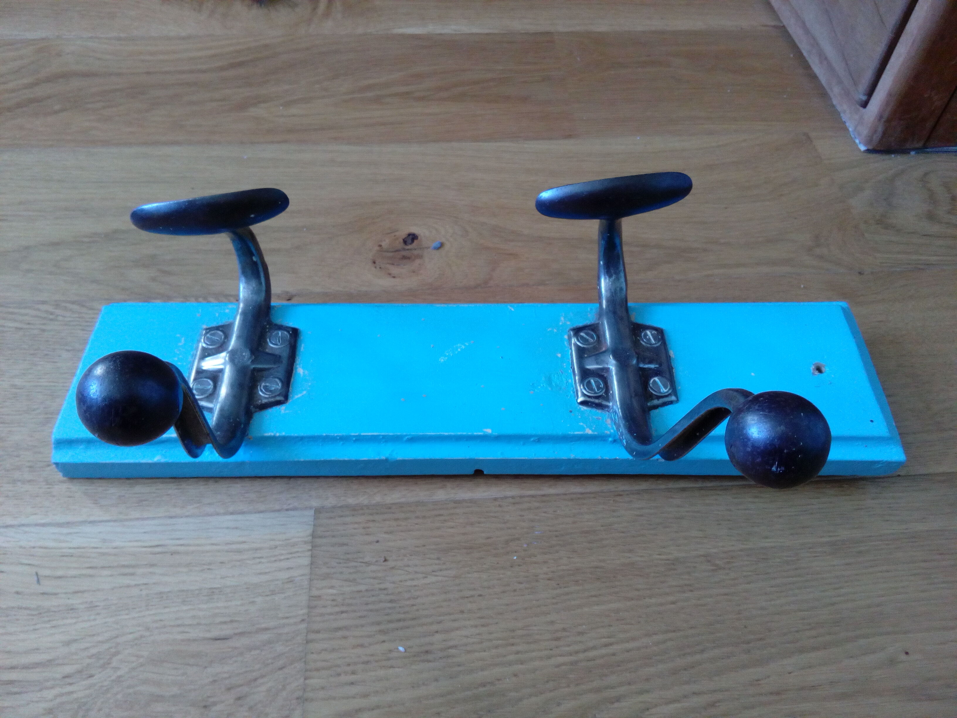 Wall coat holder with two metal pads