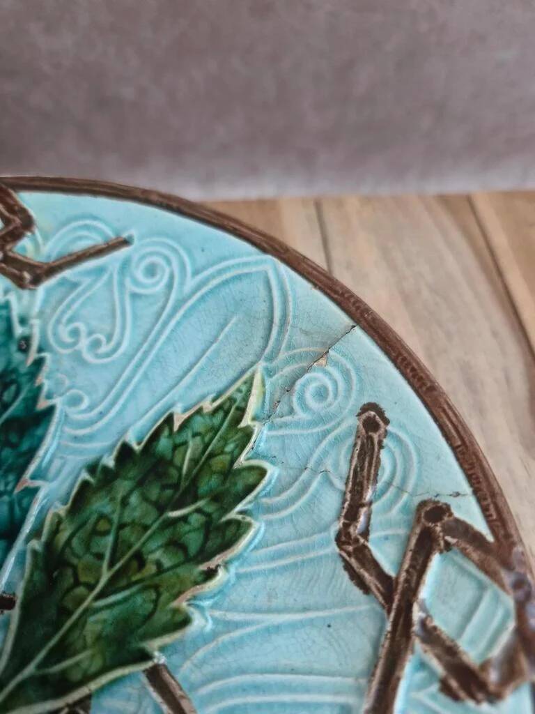 Old small compote dish in turquoise majolica with raised floral decoration.