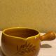 Glazed yellow earthenware fondue pot