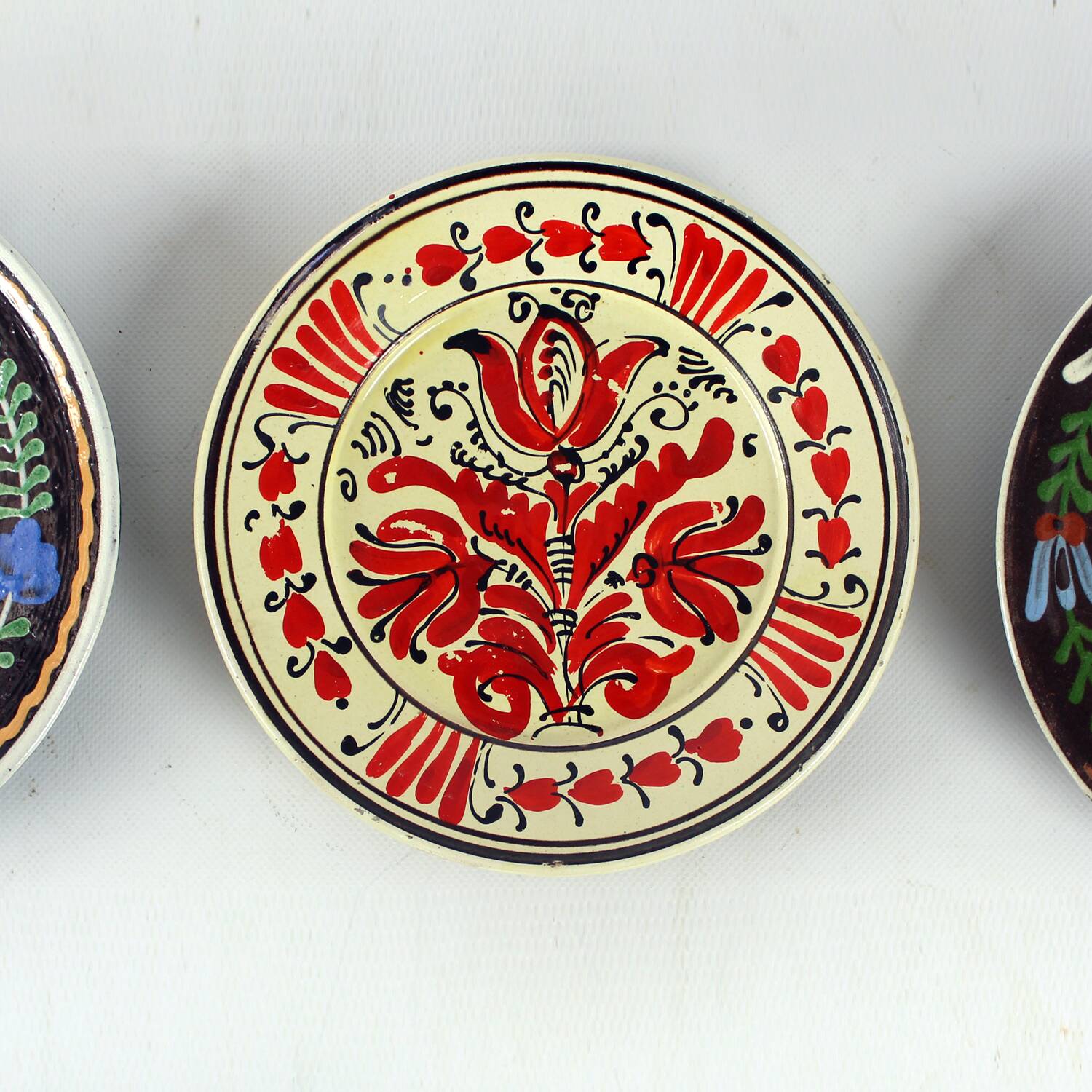 Set of three vintage folk art ceramic wall plates, Czechoslovakia and Romania.