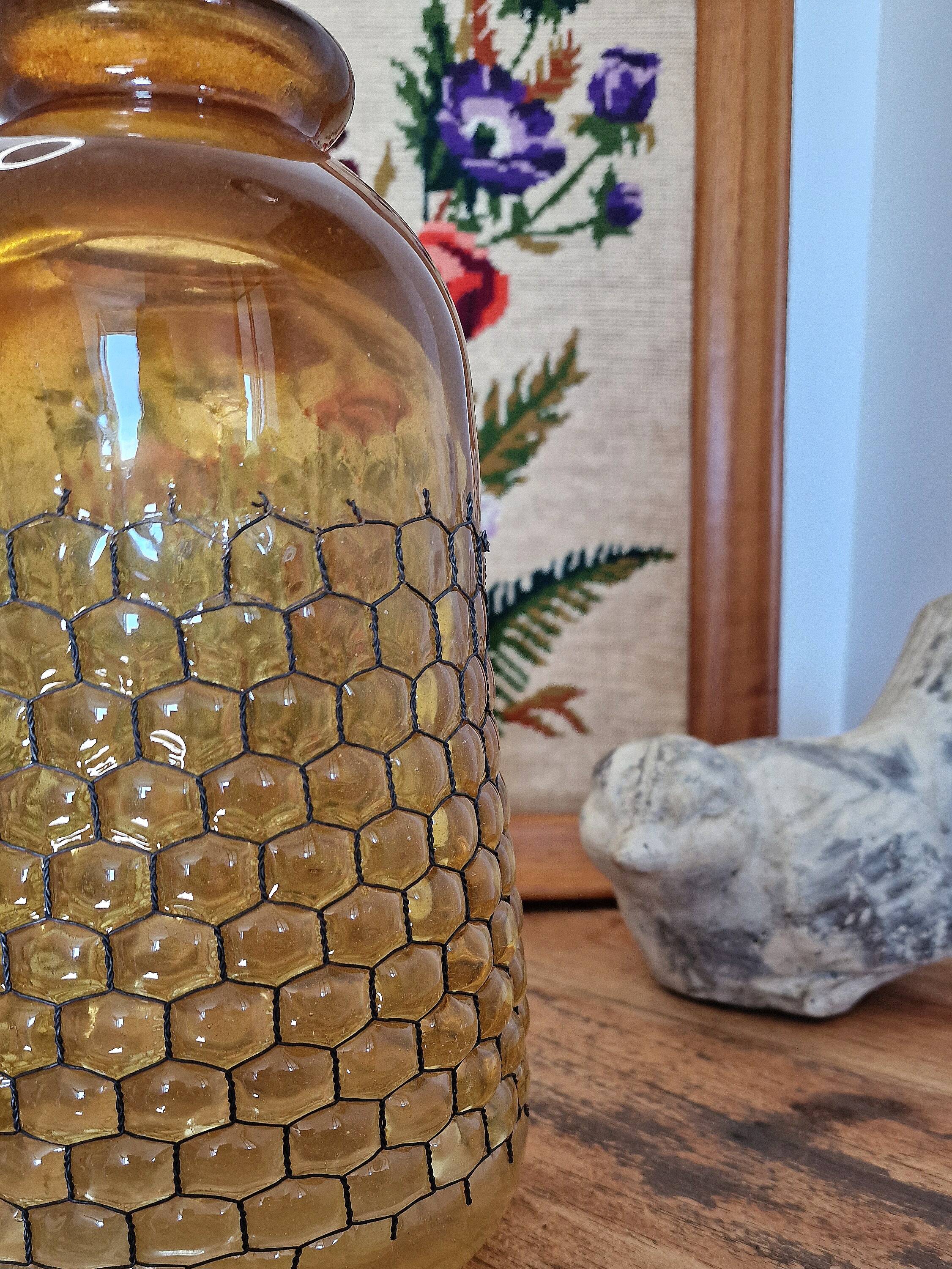 Artisanal blown amber glass vase with integrated honeycomb structure.