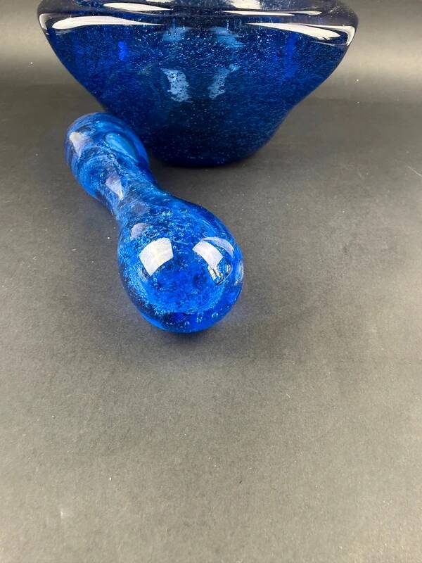 Mortar and pestle in the style of Biot, hard blue.