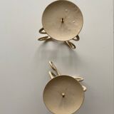 Two beige iron candle holders in a heart shape