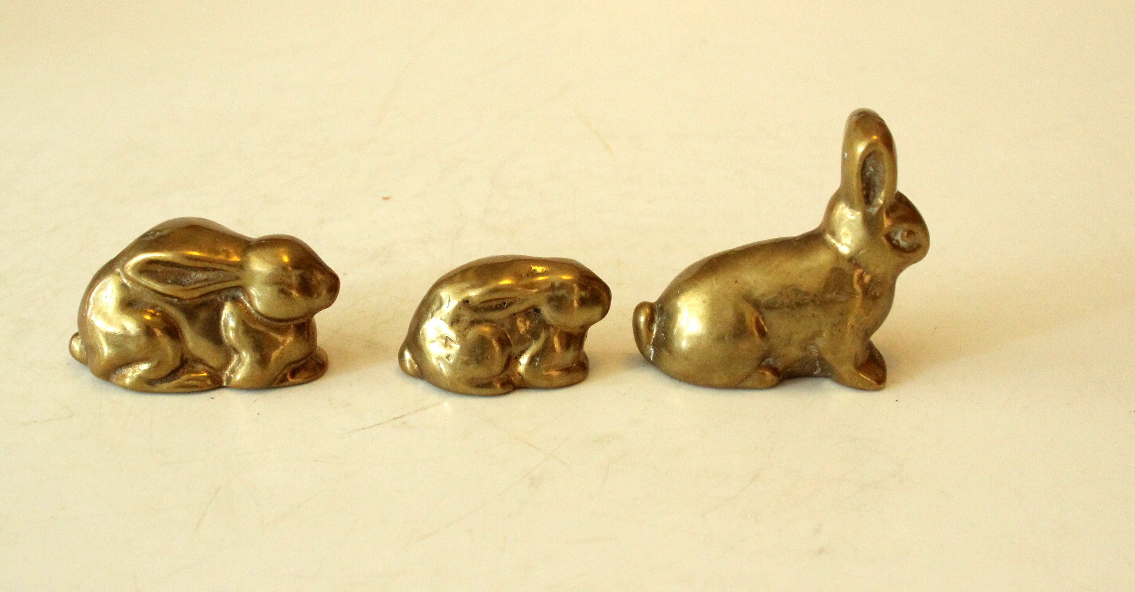 3 solid brass paperweights in the shape of rabbits vintage from the 1960s