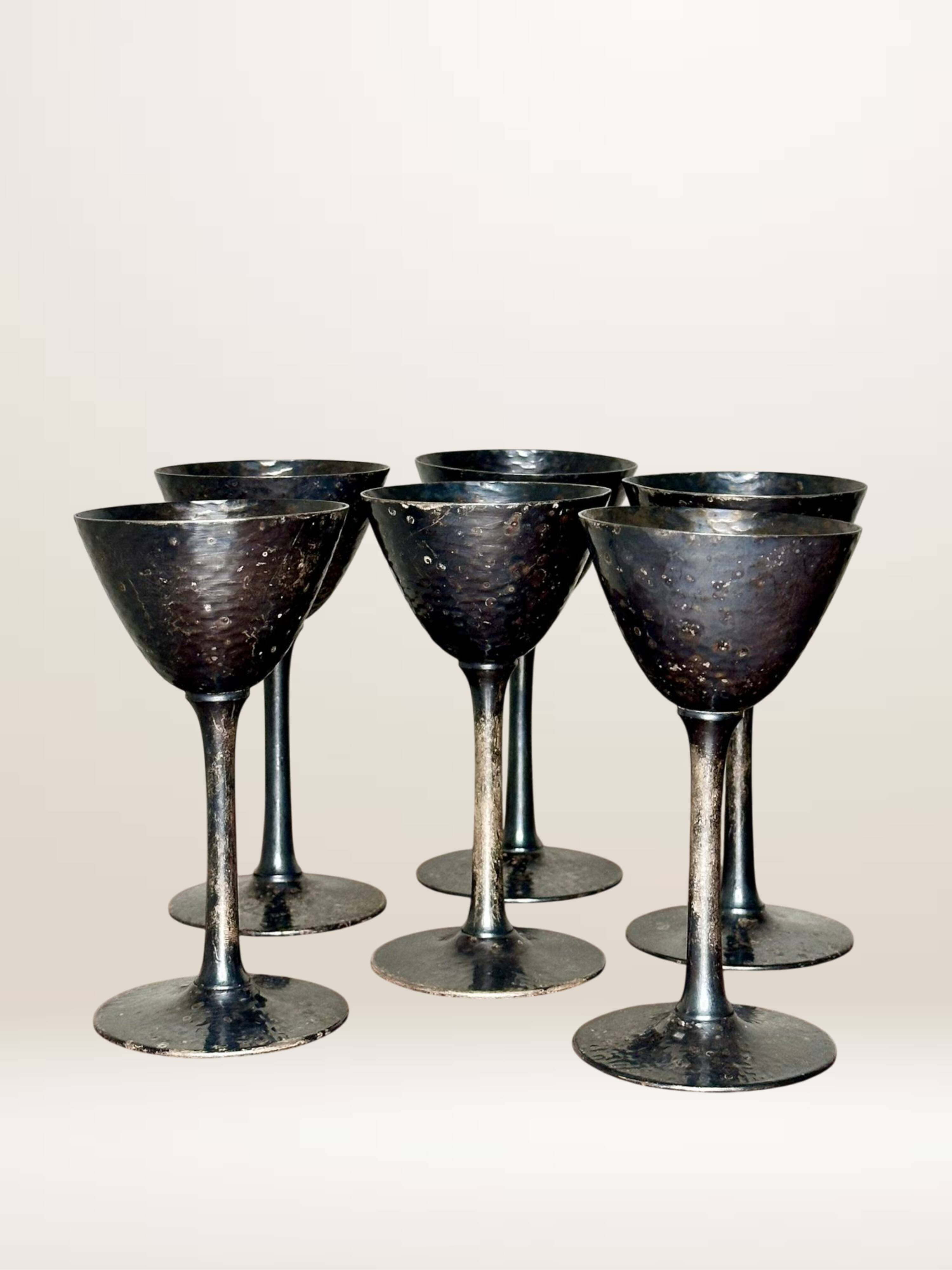 Set of six hammered metal goblets.