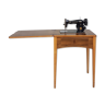 Sewing table with integrated singer machine