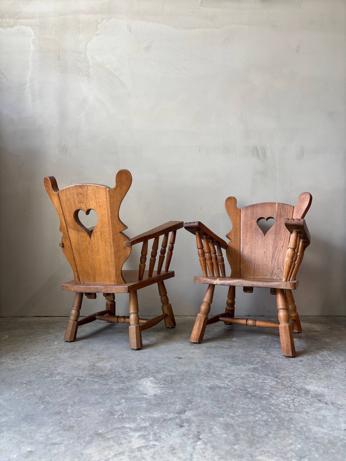 Pair of rustic oak armchairs – carved heart backrests