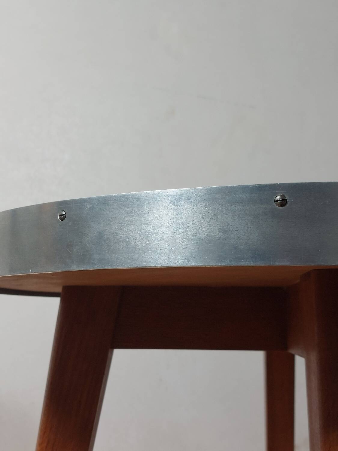 Vintage metal and teak side table from the 1950s.