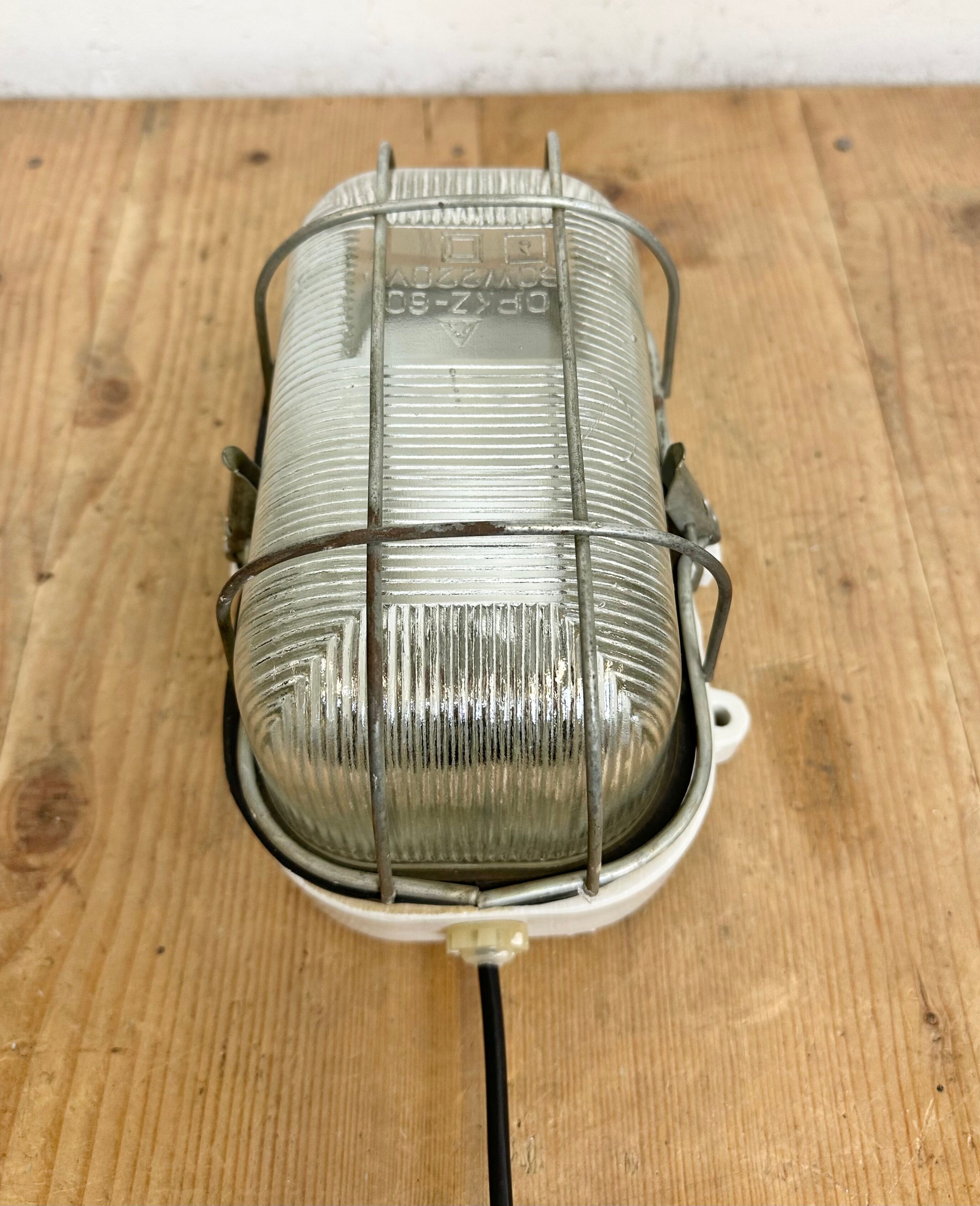 Industrial white porcelain cage wall light with ribbed glass, 1970s