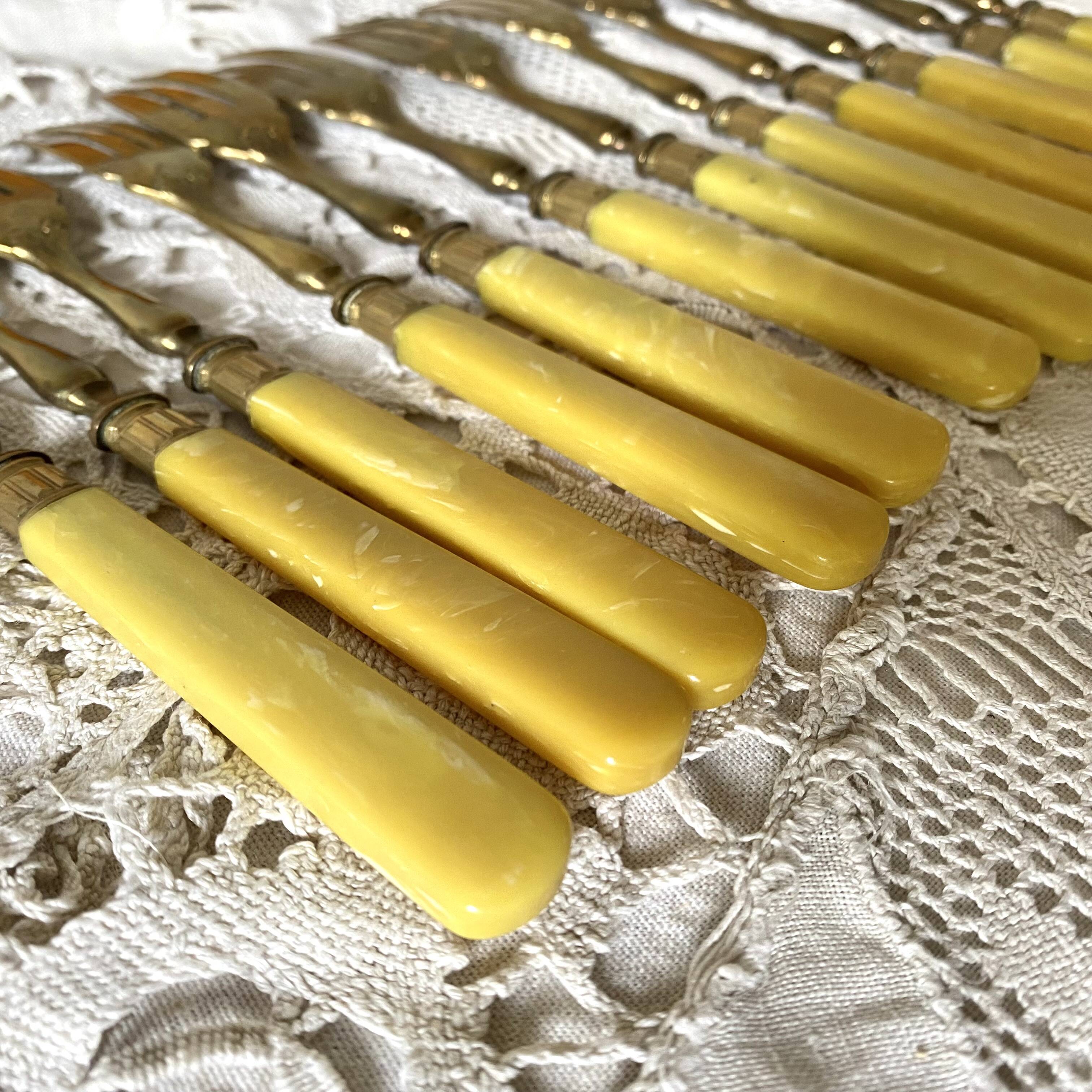 Antique dessert forks in brass and bakelite