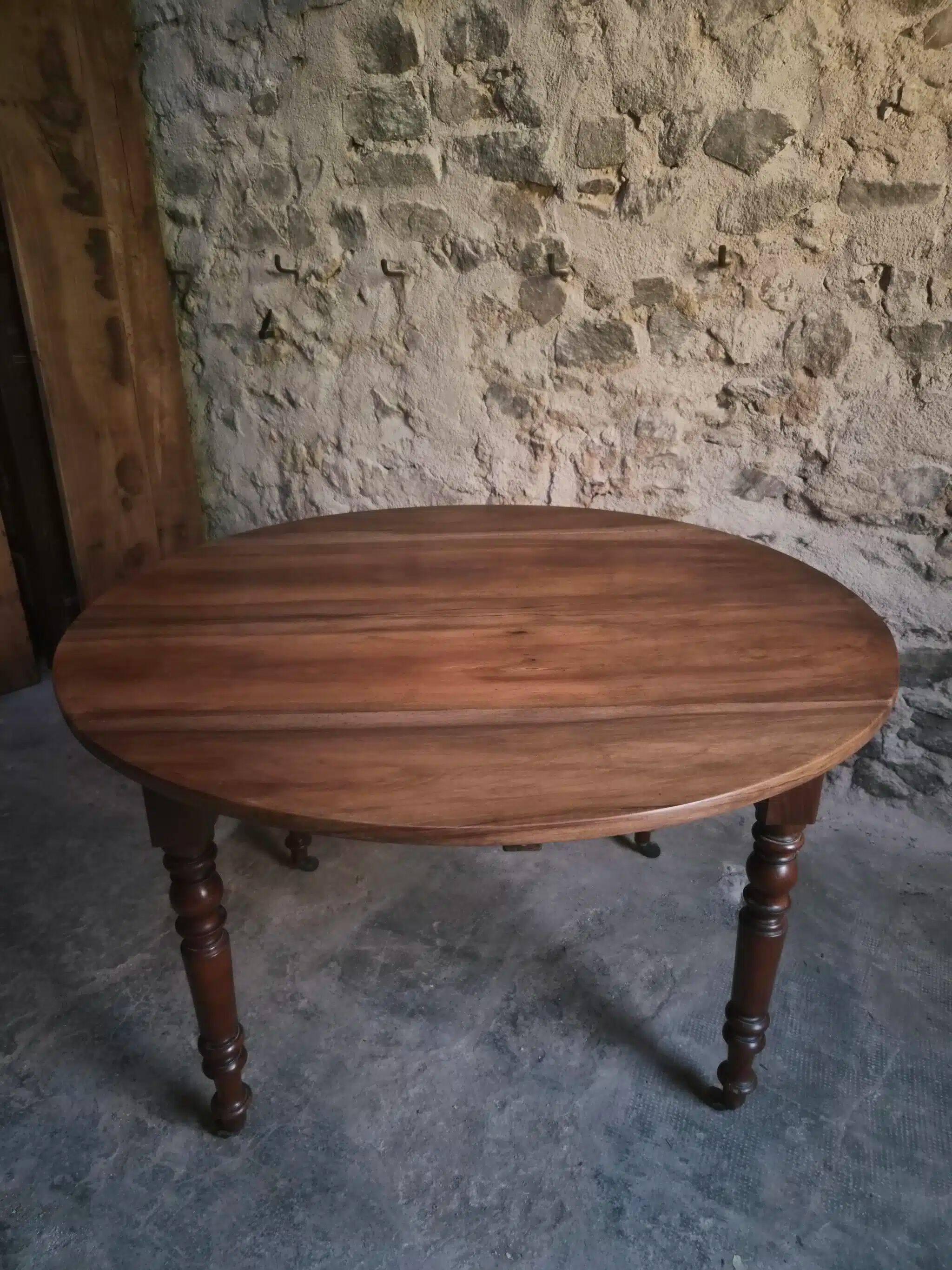 Antique drop-leaf dining table in walnut, France, circa 1900.