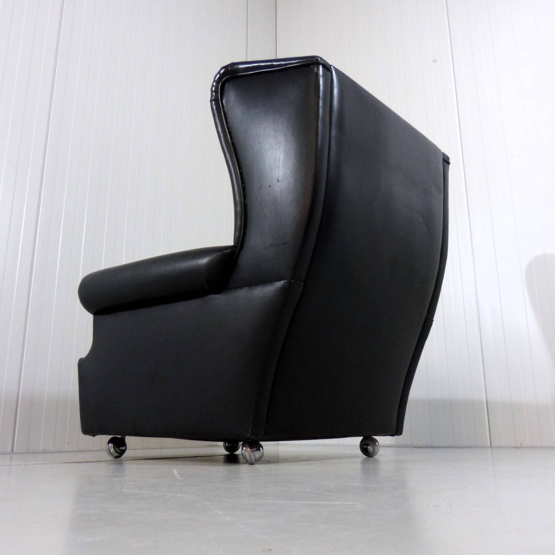 Black leather wingback chair on wheels 1960’s