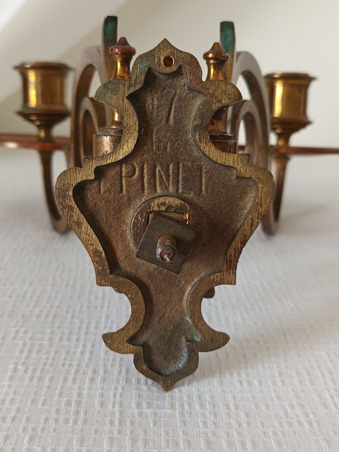 Pair of antique wall-mounted brass candle holders