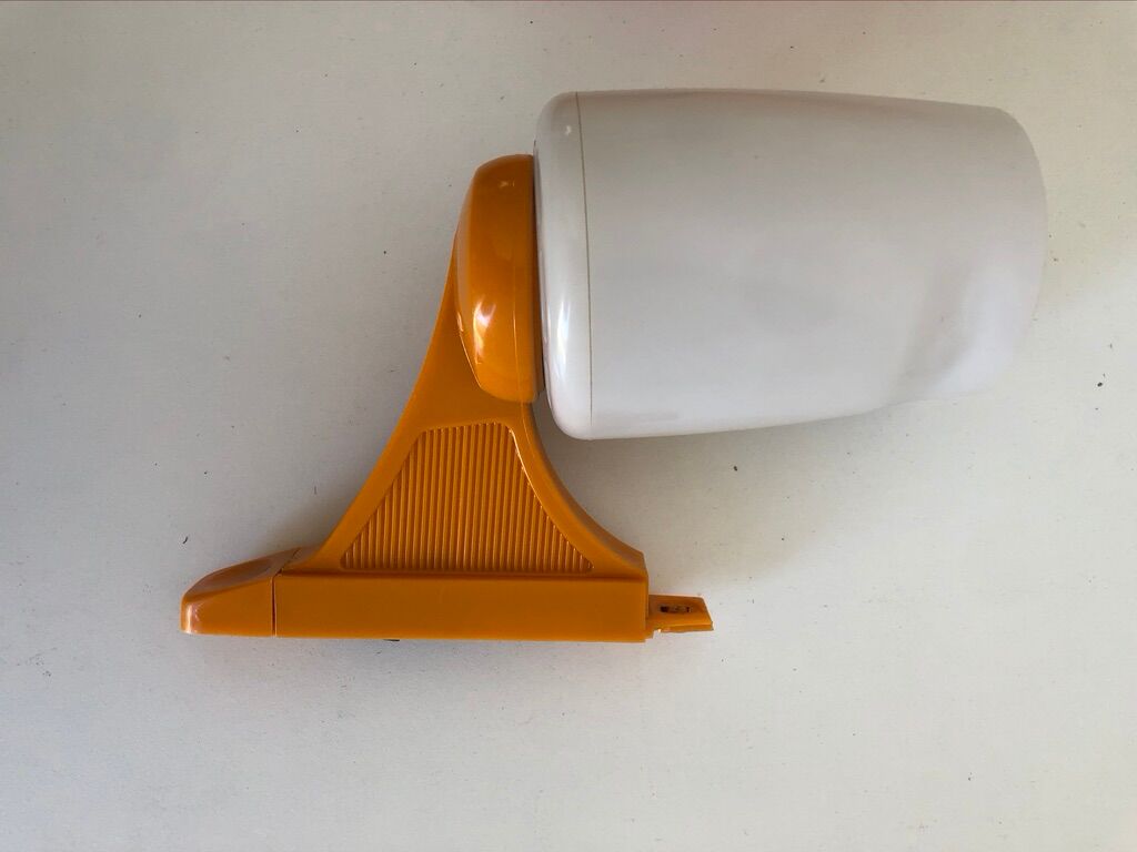 Tiltable orange plastic mirror with matching wall light