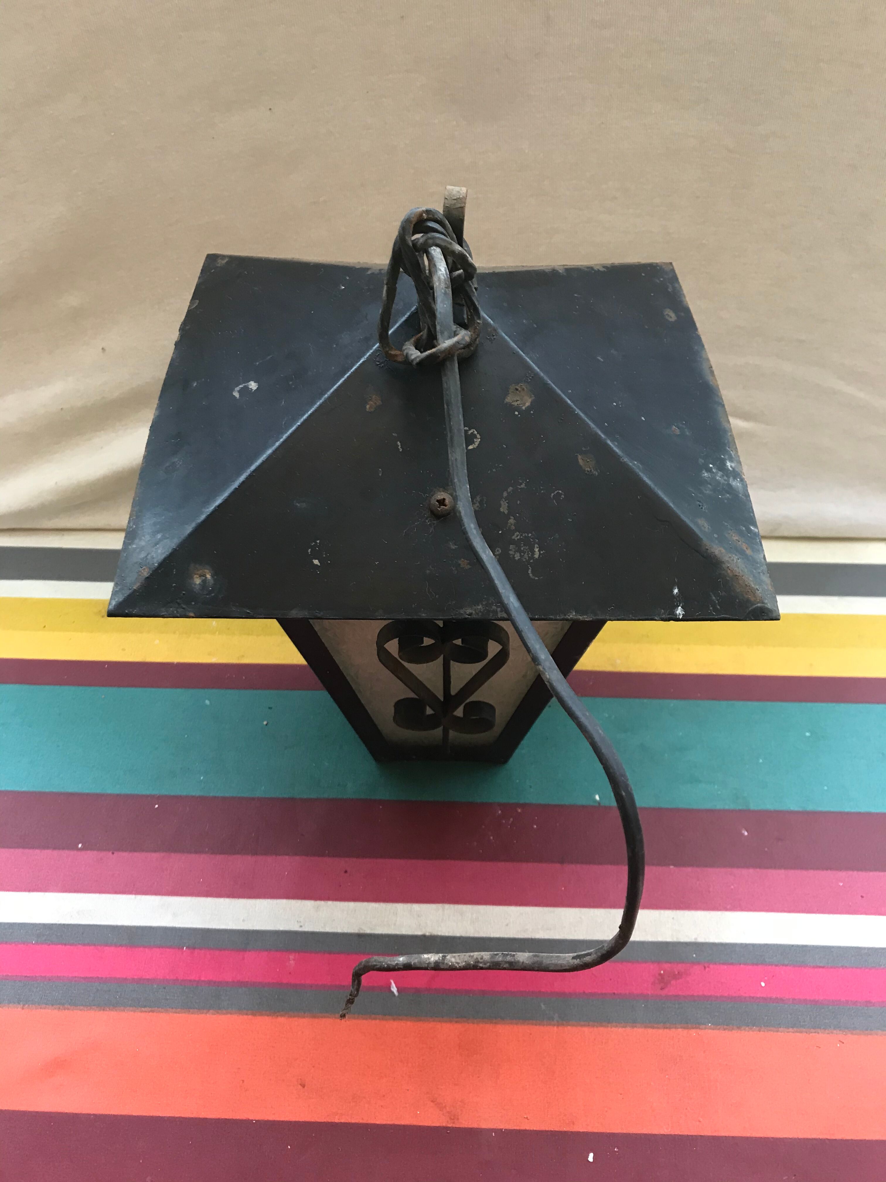 Old black forged iron suspension vintage in moulded glass