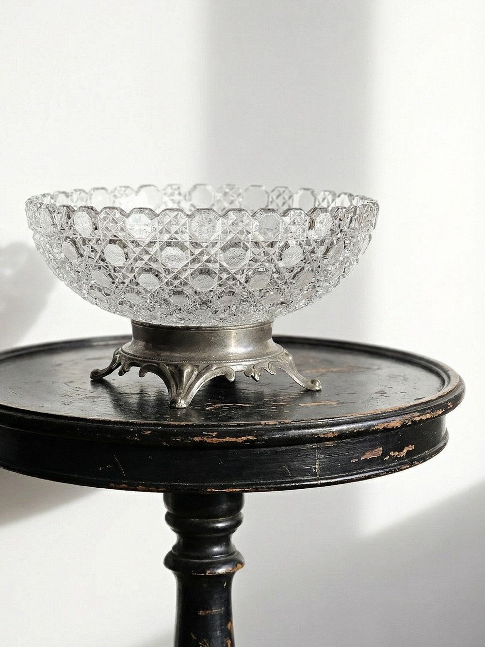Pressed glass coupe with diamond points, antique from 1920-1950 on a pewter base.