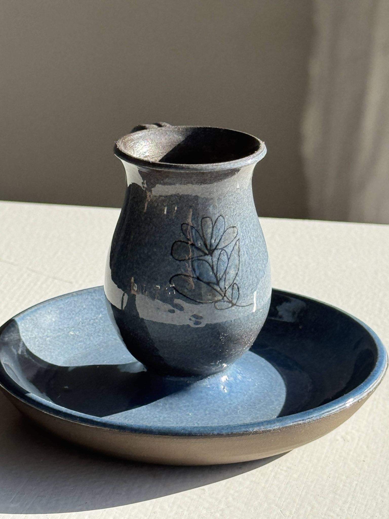 Vintage hand-held candlestick in blue glazed stoneware with floral decoration by Poterie Millian.