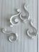 Set of 4 white lacquered metal hooks,