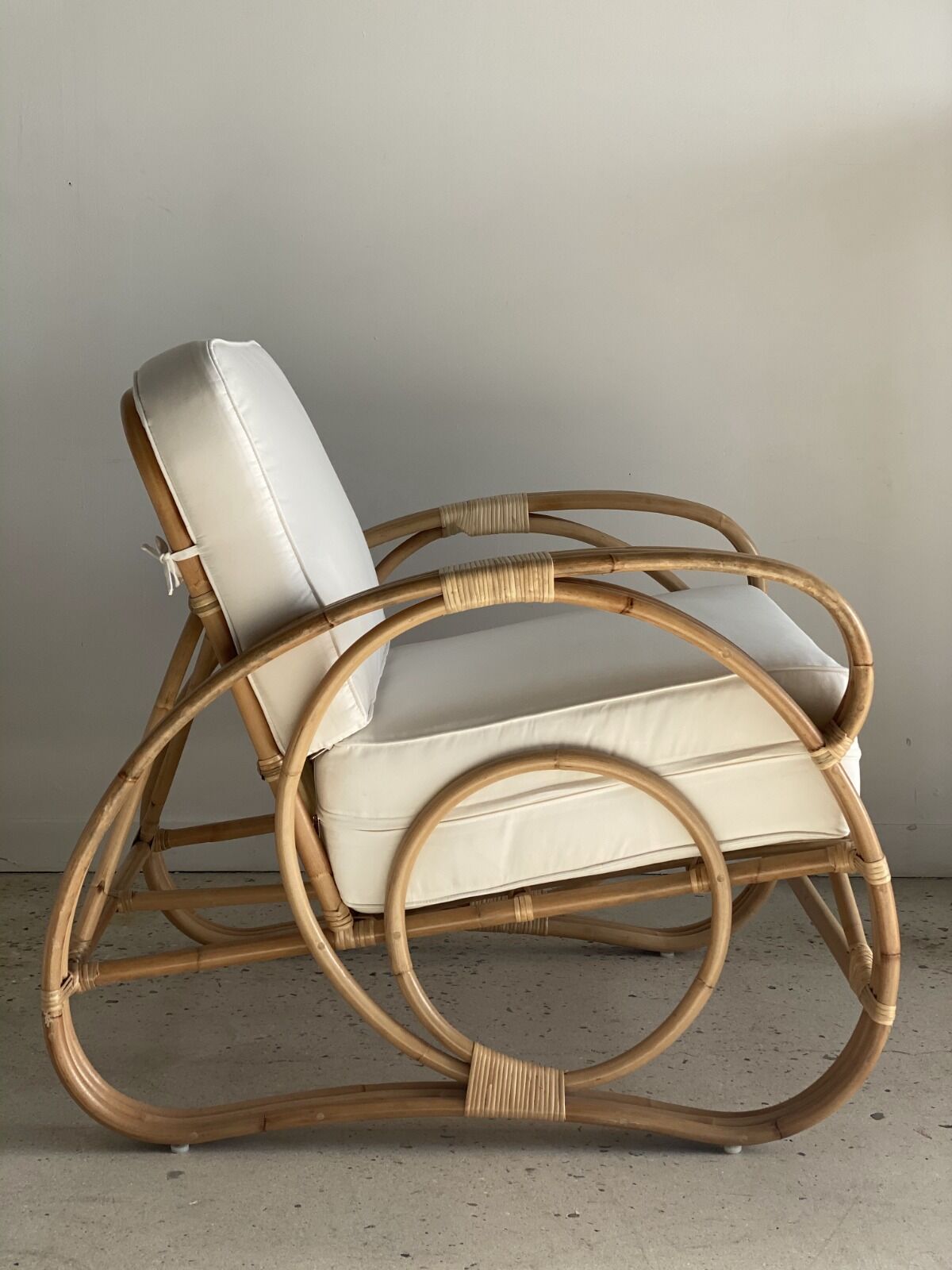 Large rattan rest chair and white cushions