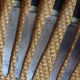 A set of 8 knives with black wooden handles and bolsters.
