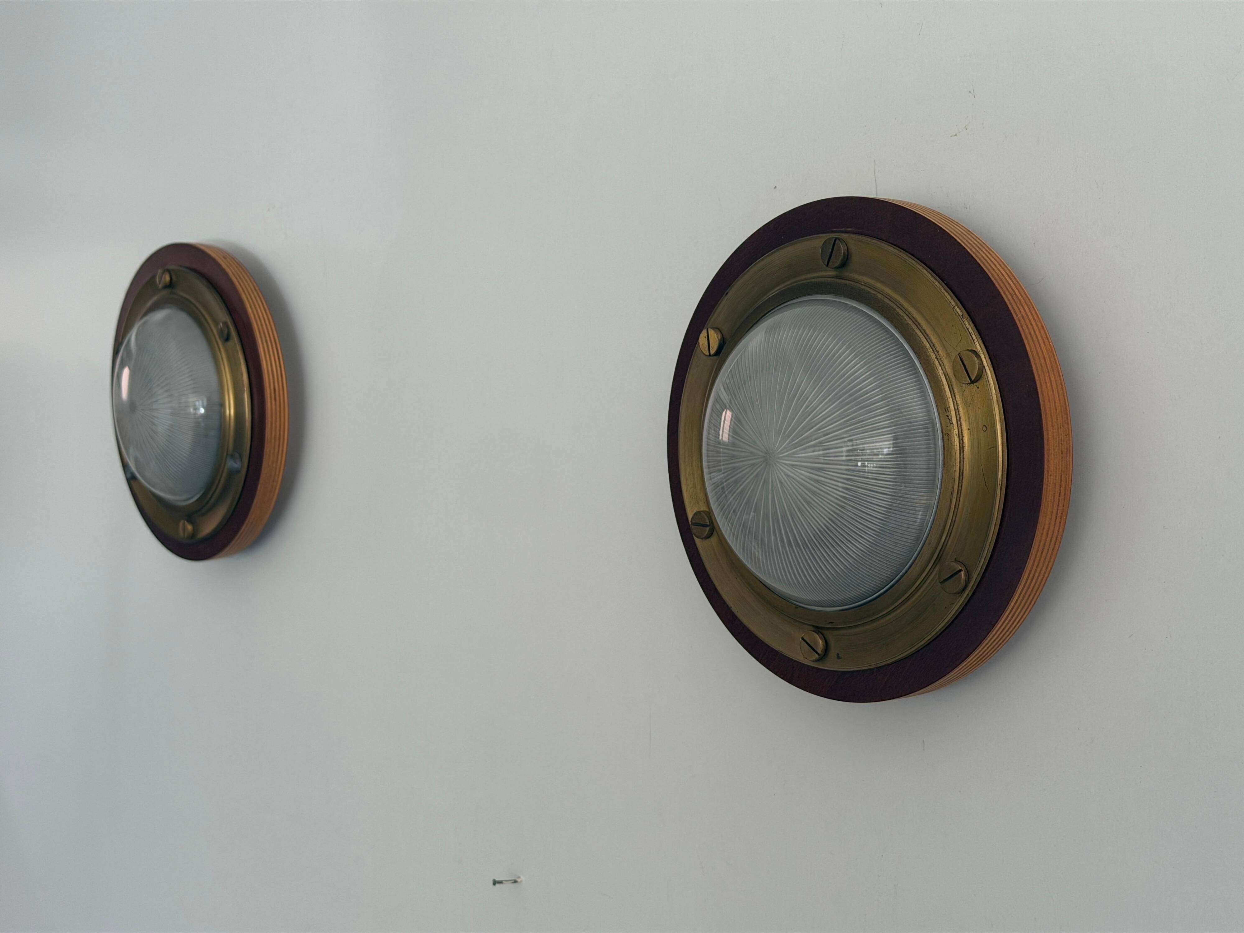 Pair of round glass wall lights, brass base and Wood Wood, 1960s, Italy.
