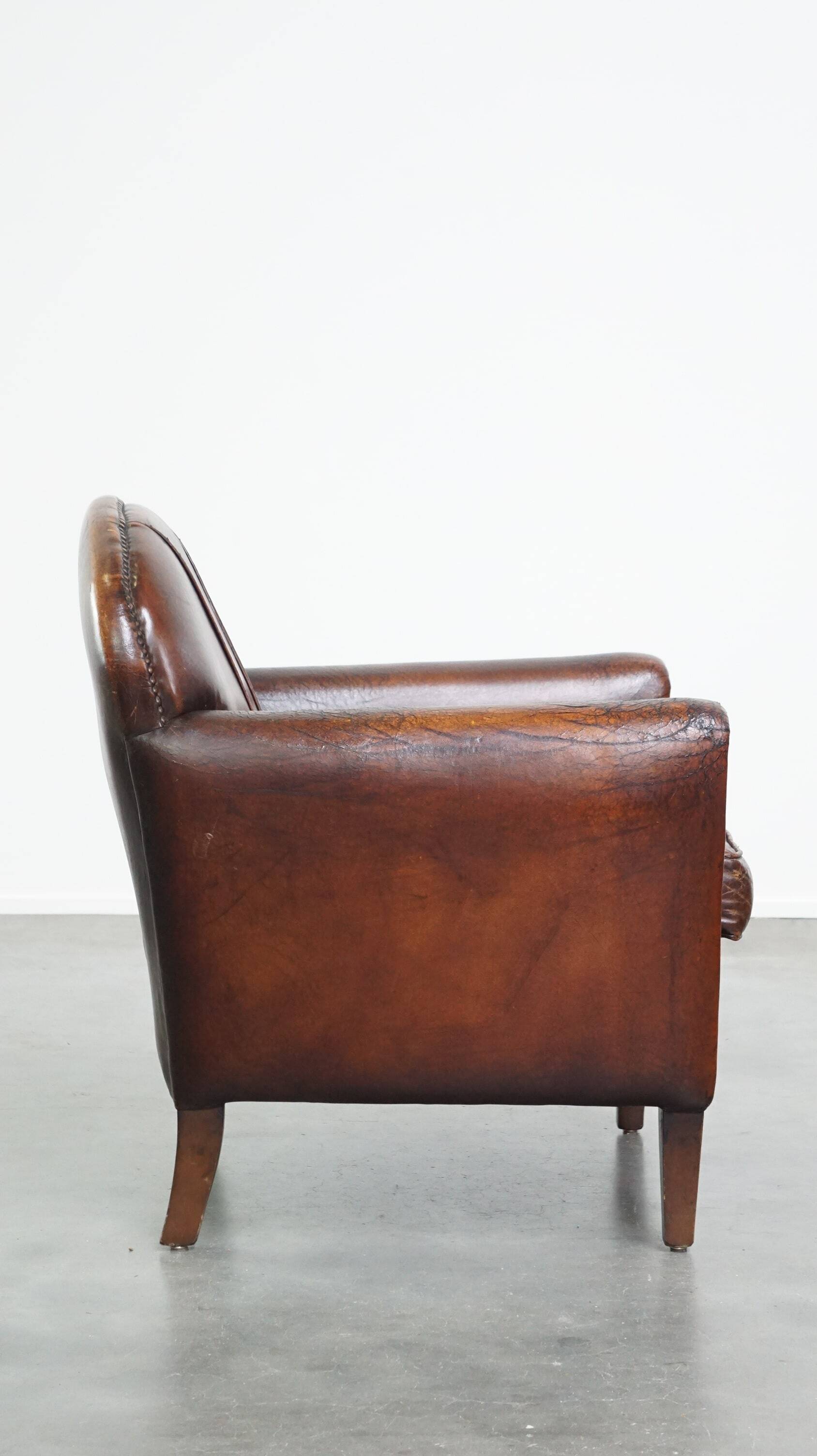 A vintage-style armchair with character, upholstered in beautifully patinated sheepskin.