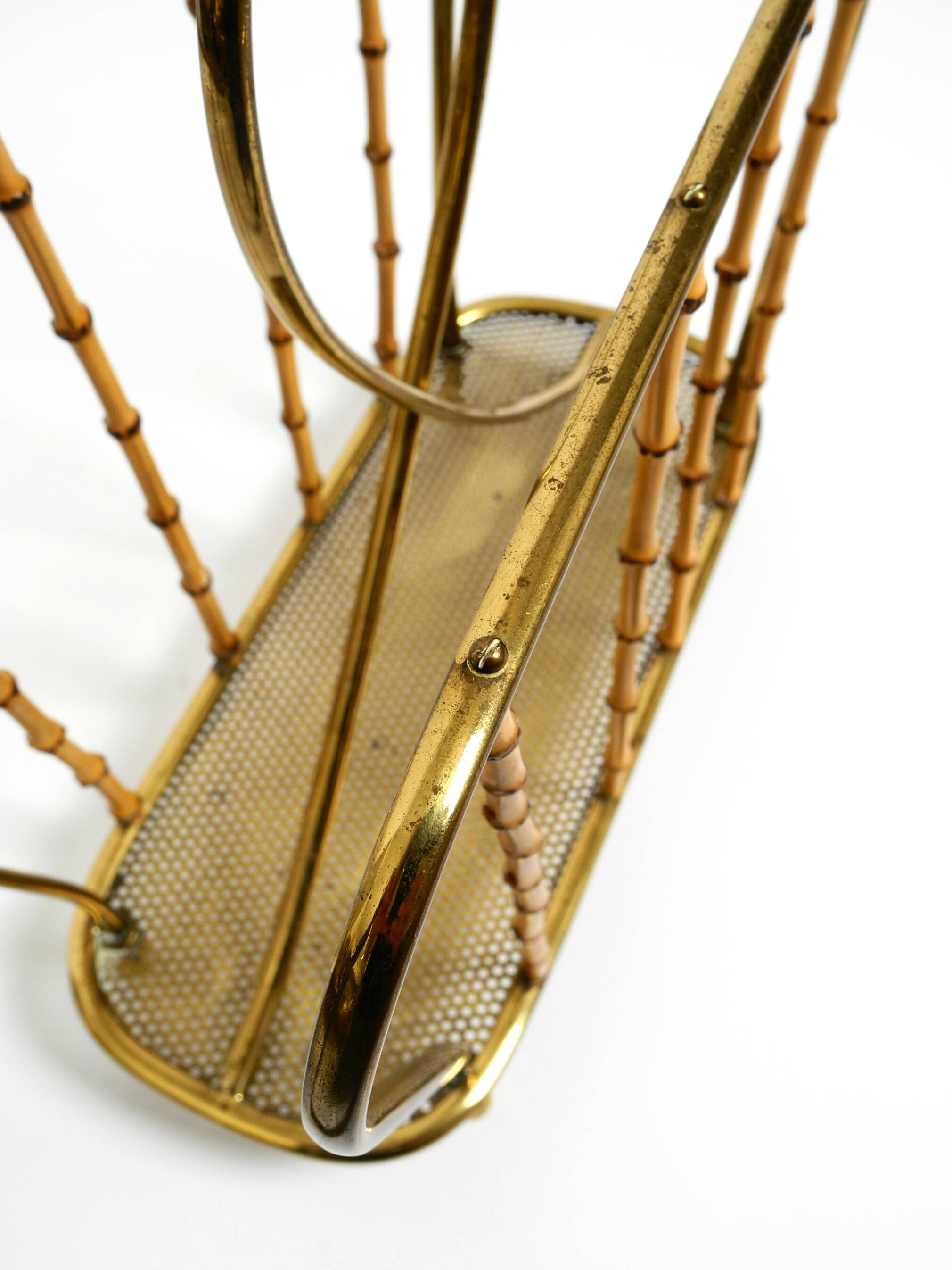 Rare Mid Century Modern magazine rack made of solid brass and genuine bambo