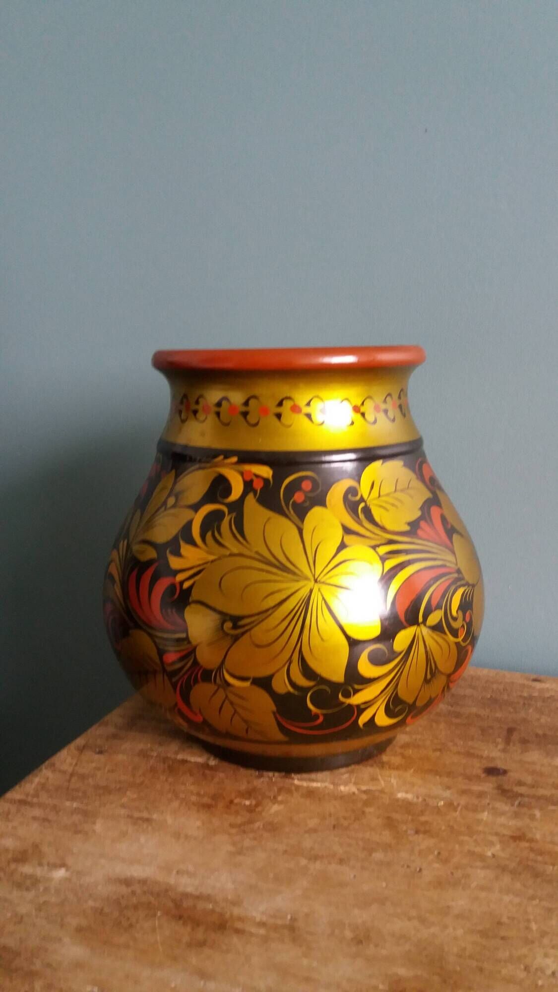 Khokhloma vase, Russian lacquered wood craftsmanship, hand-painted floral decoration.