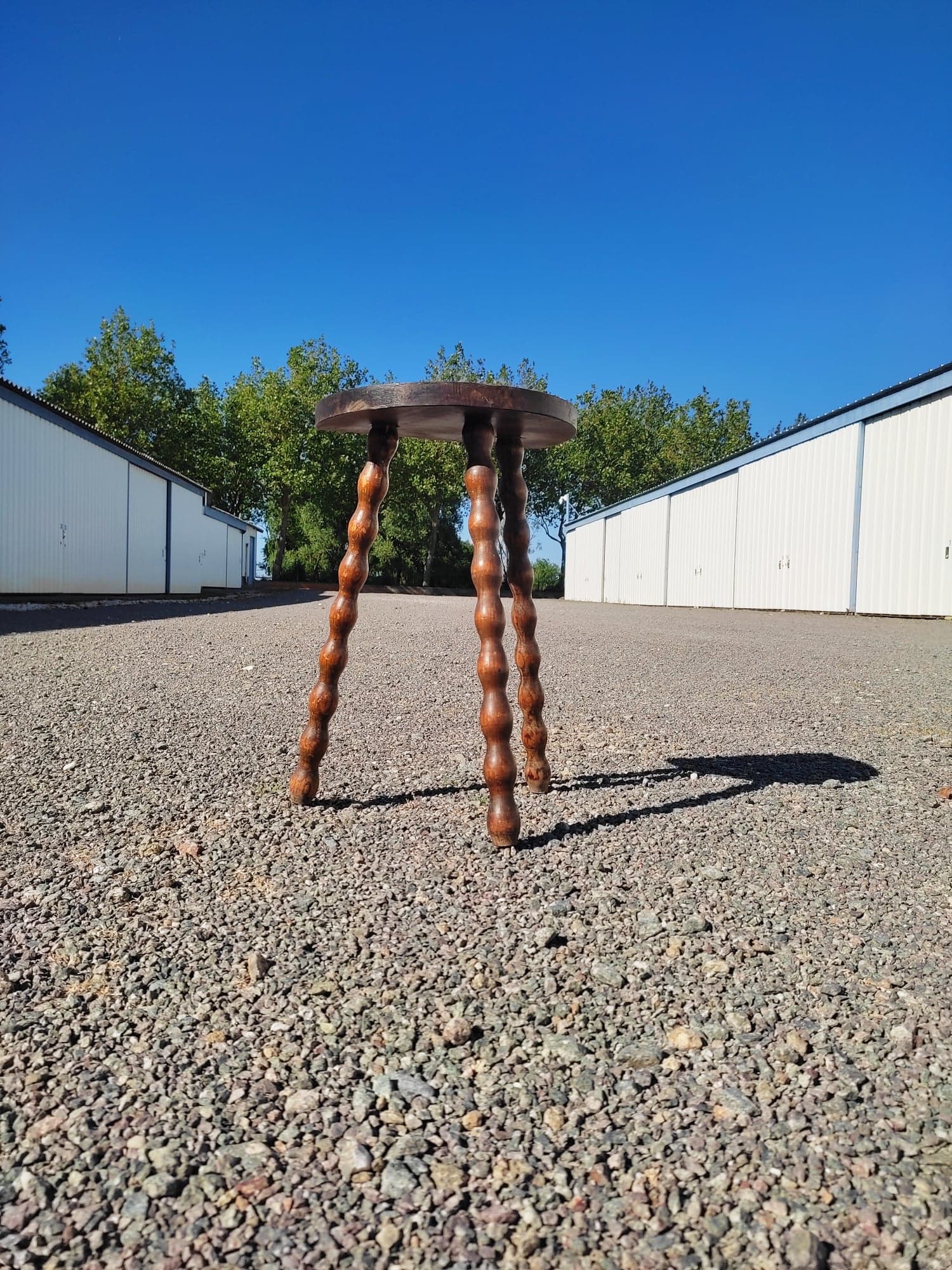 Pretty wooden stool with half moon seat and turned wooden tripod base