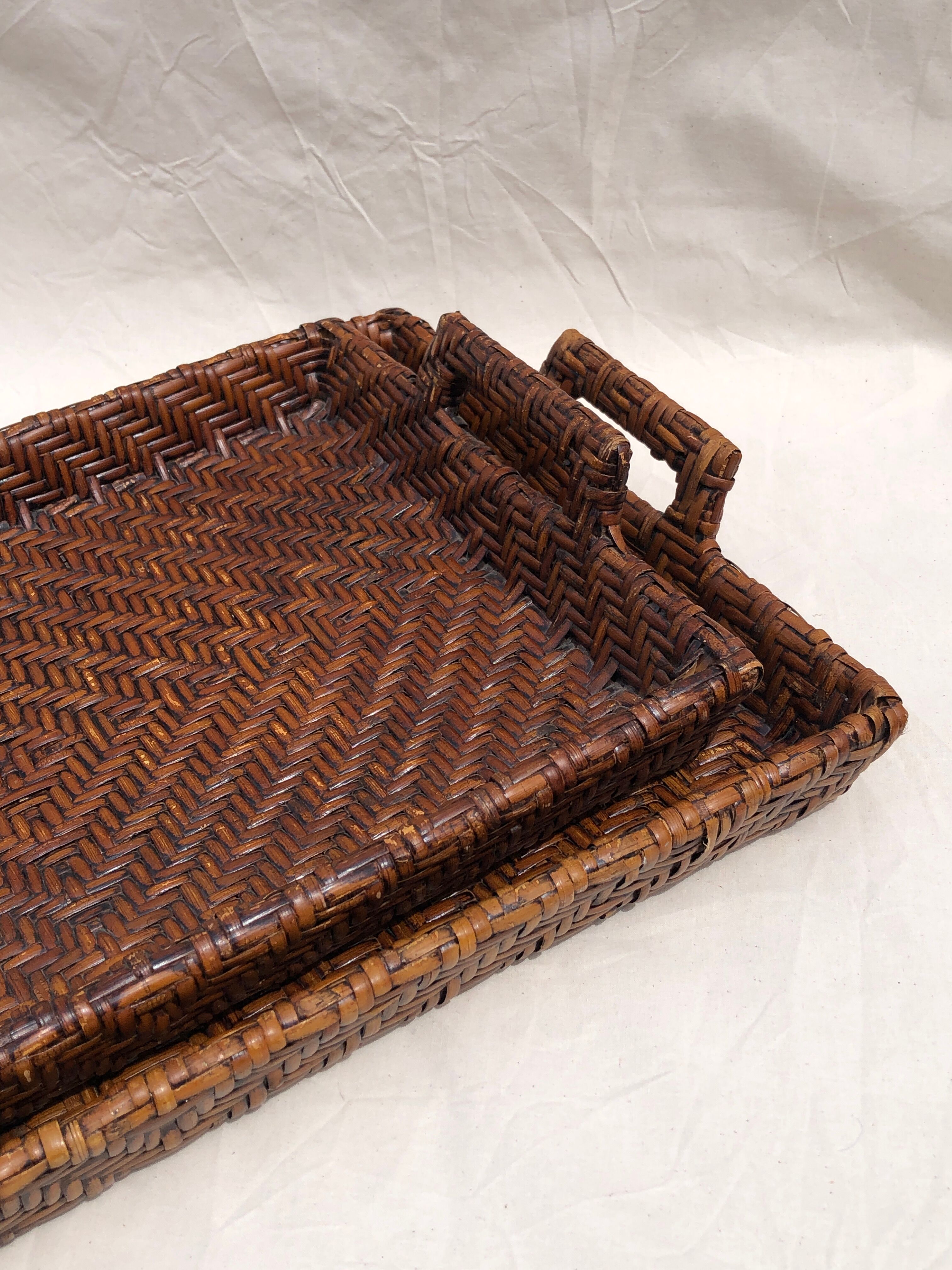 Pair of dark rattan trays