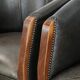 Set of two cowhide and wooden tub chairs with a sturdy colour scheme