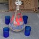 Peacock pattern liqueur decanter and 4 small vintage cobalt blue glasses
