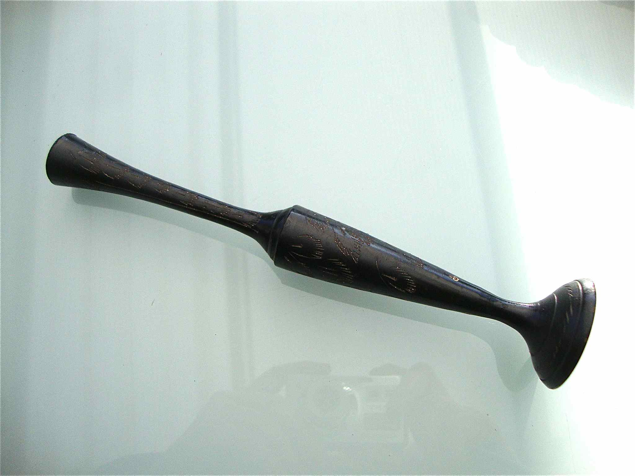 Stylized vase in engraved metal