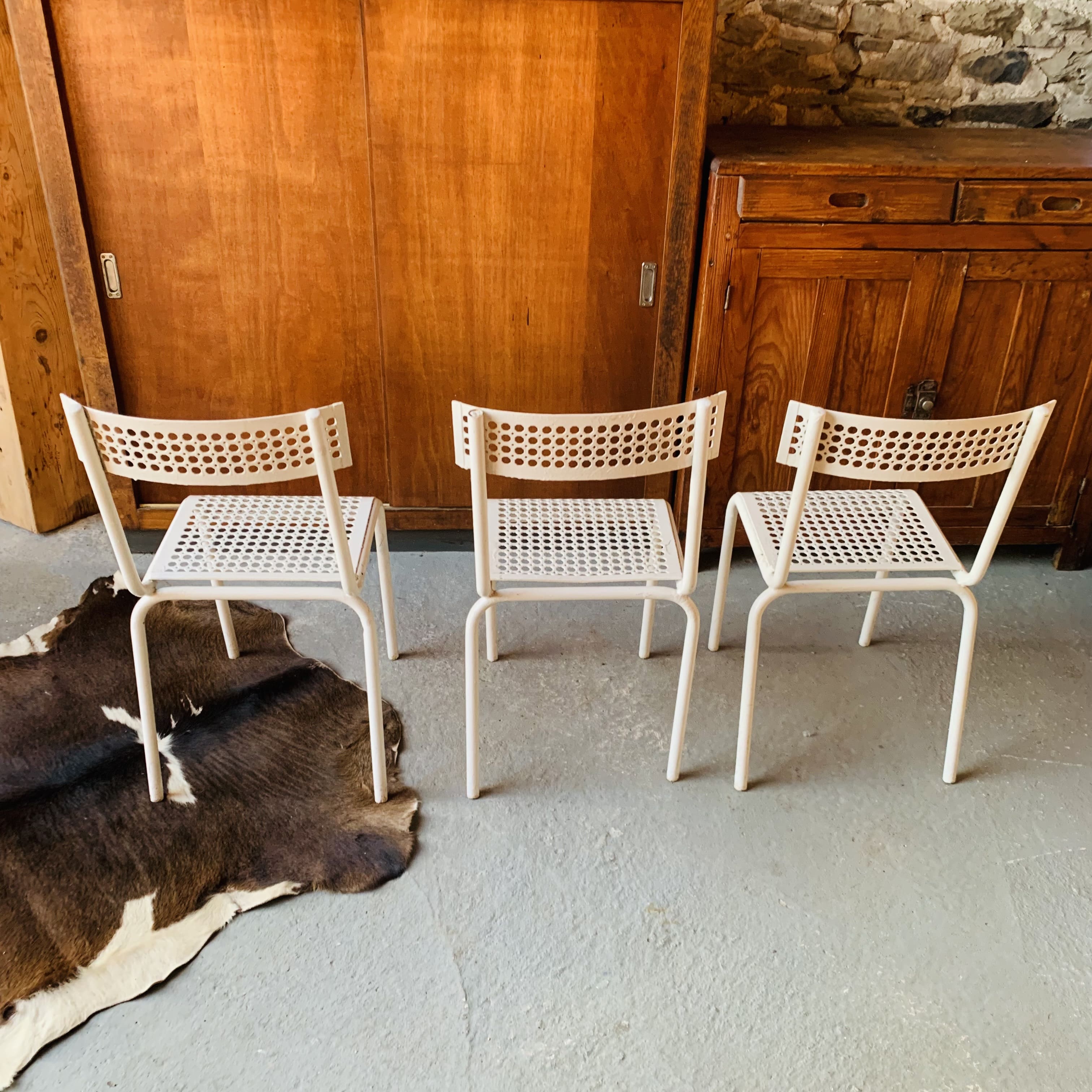 Series of 3 perforated metal chairs
