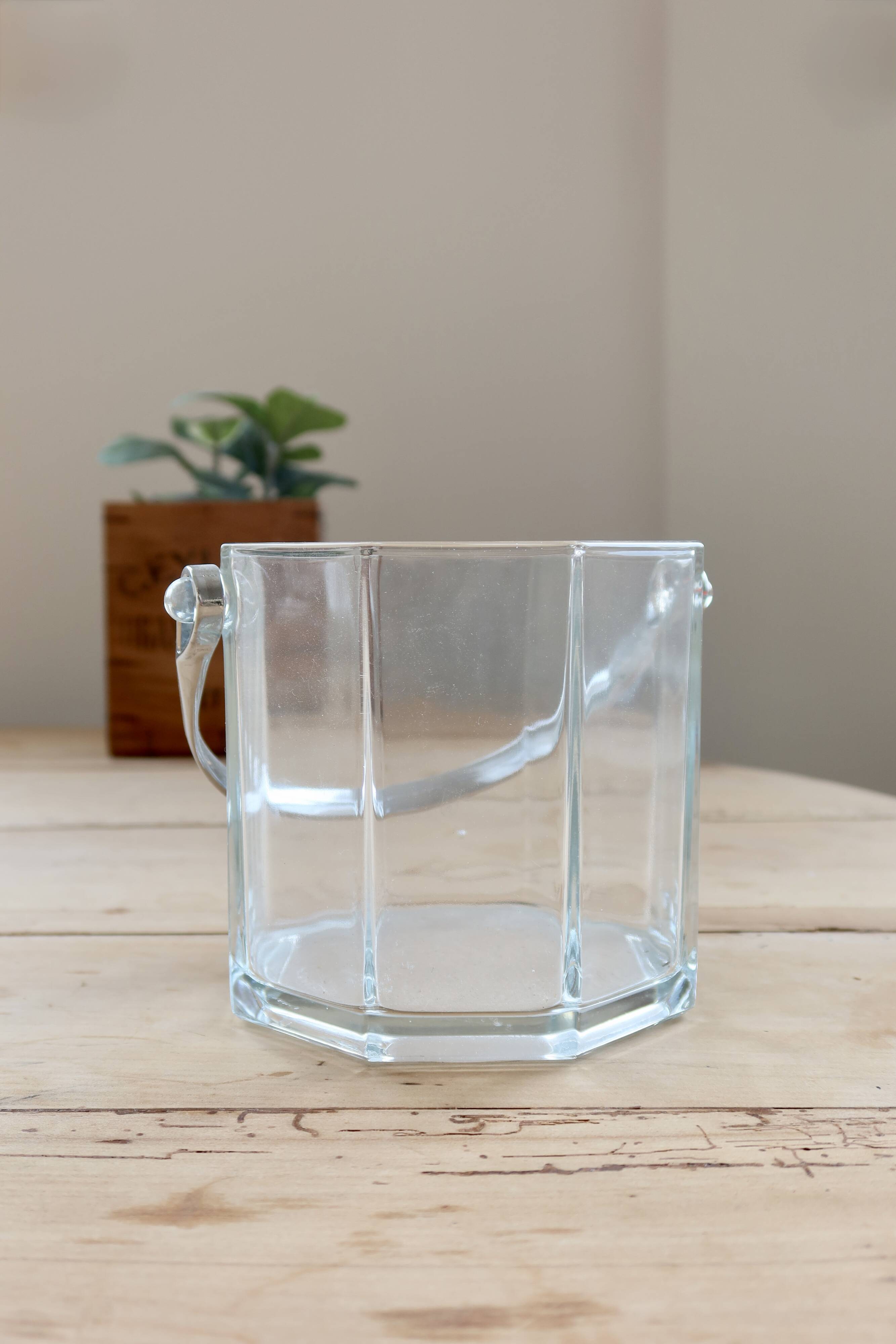 Vintage glass ice bucket with chrome handle.