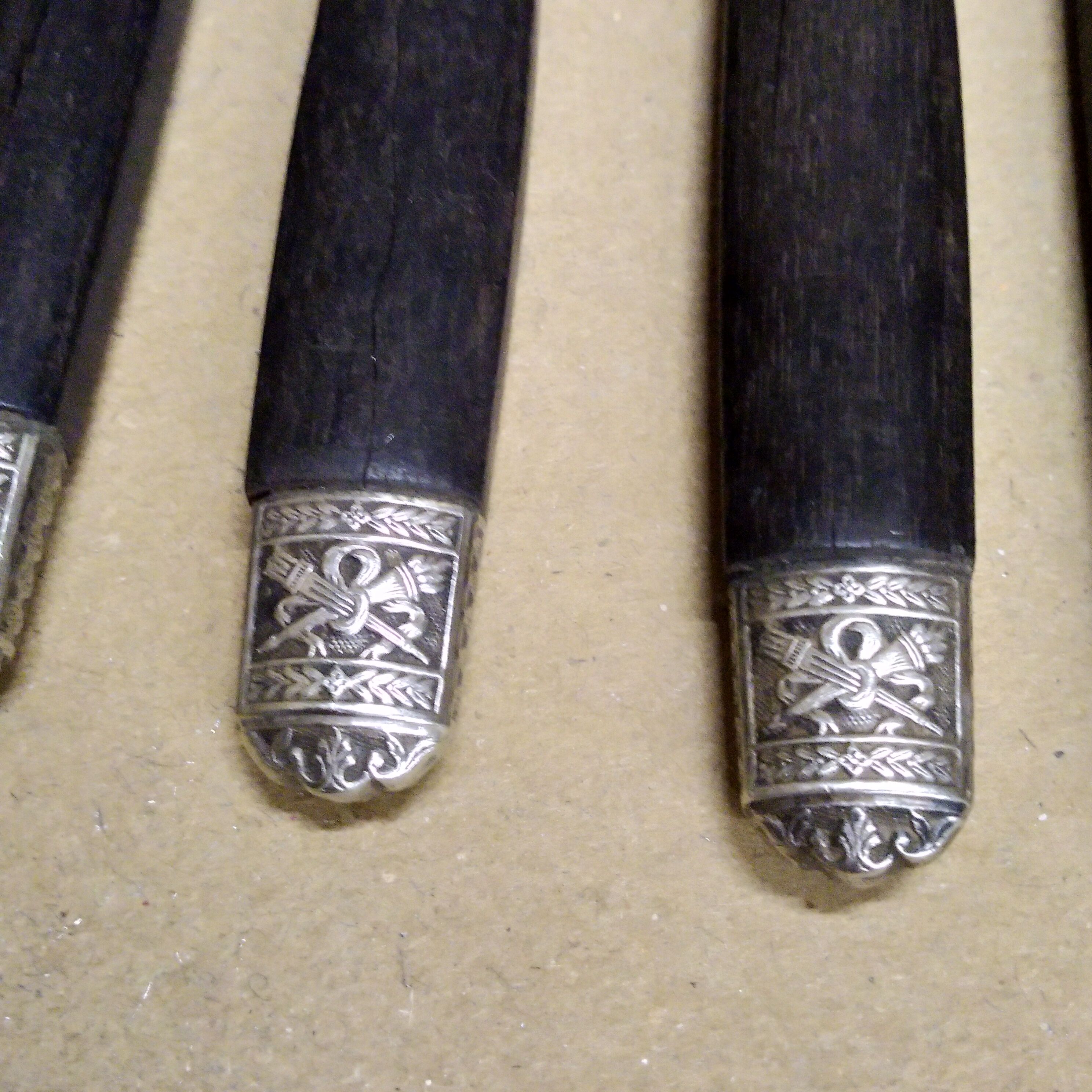 12 Silver dessert knives, ebony, steel, late 19th century