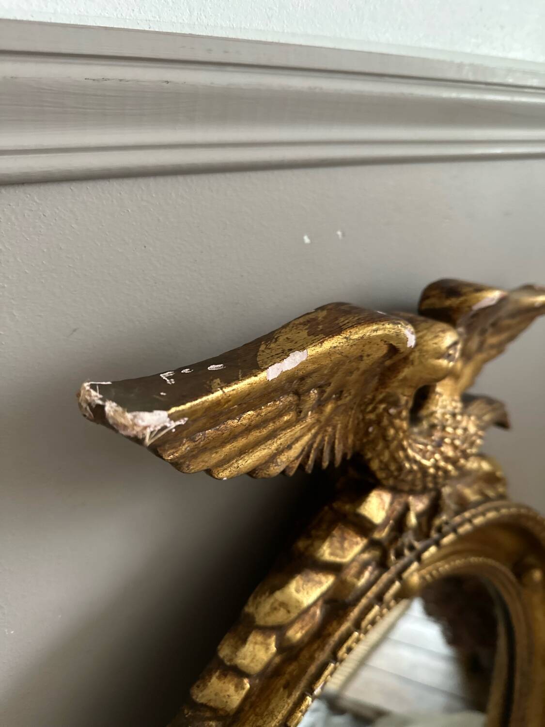 Antique gilded mirror decorated with an eagle