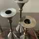 Trio of vintage metal and bronze candle holders