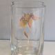 Glass vase with a decoration of a golden flower, around 1970.
