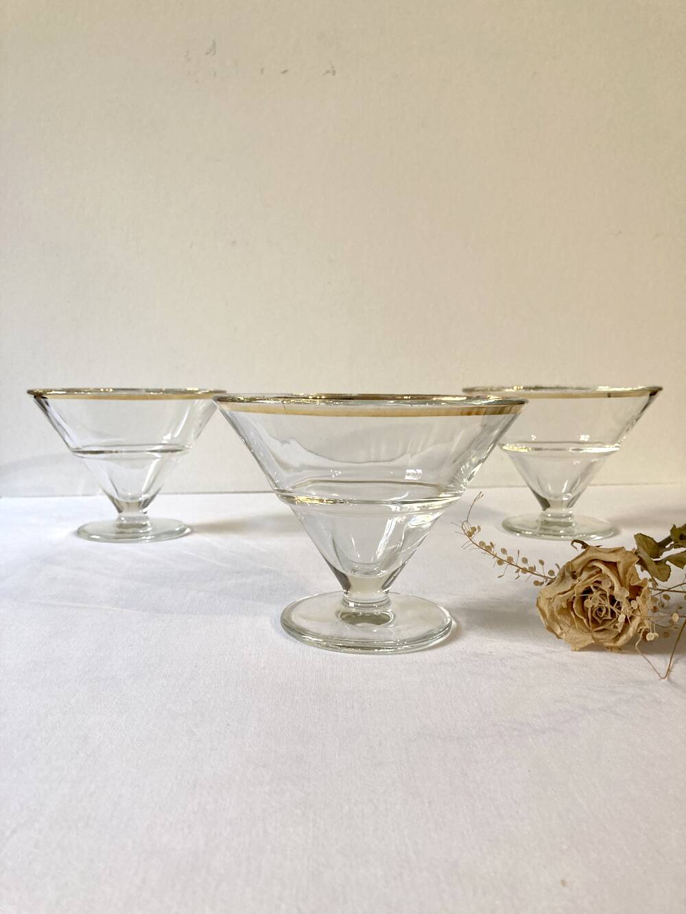 Trio of glass dessert bowls with gold rims, La Rochère, France