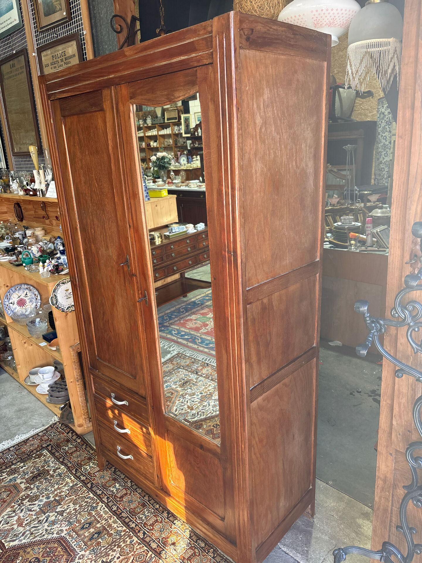 Antique Parisian wardrobe with mirror, hanging space and drawers.