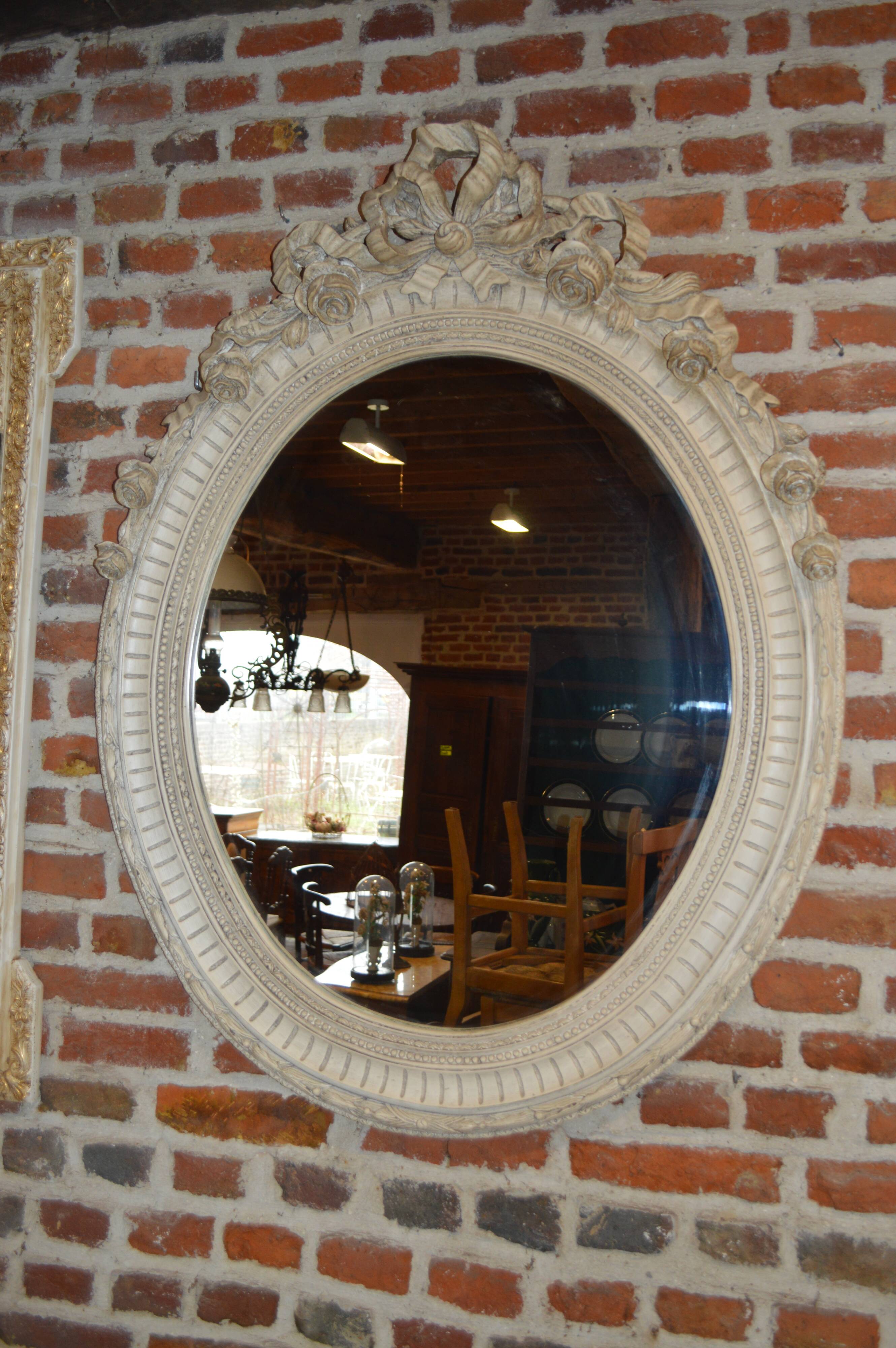 white patinated oval mirror with a bow and roses  88x115cm
