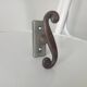 Old window handle with a forged iron cremon.